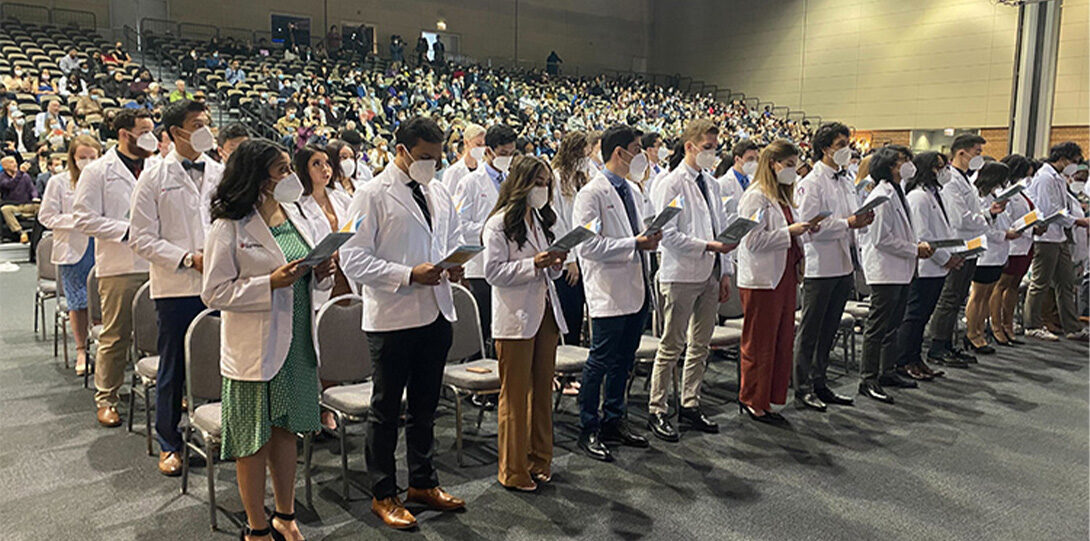 Students with white coat standing
