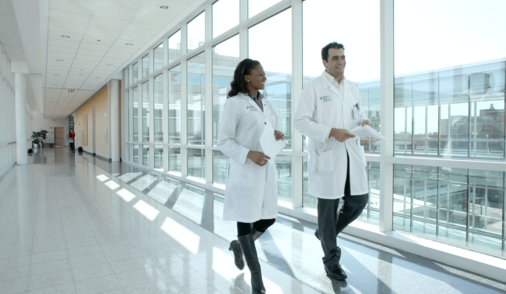 Students with white coat walking down the hall