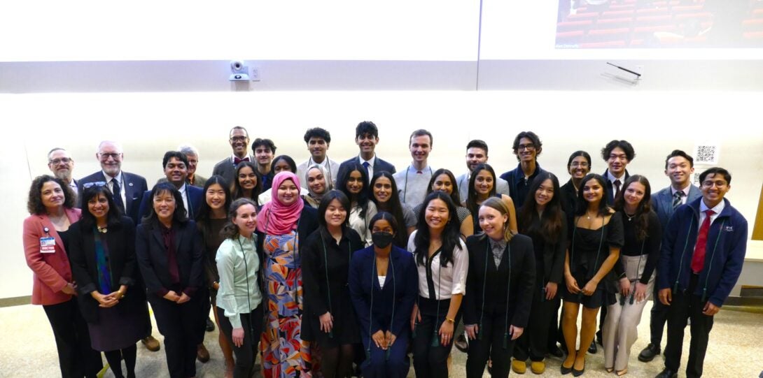 A group of students gather and smile